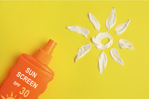 a sunscreen bottle in bottom left corner with a sun made from the sun lotion in the opposite top right corner.